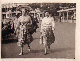 Women stroll on the sunny seaside