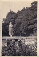 Woman standing gracefully by a serene waterfall