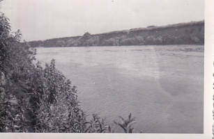 Calm waters flow by lush banks in quiet serenity