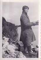 Reading quietly by the riverbank on a chilly day