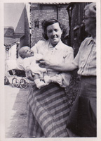 Holding a newborn on a sunny stroll through town