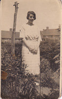 Young woman standing in a garden during summer