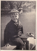 Smiling child by the serene pond in vintage attire