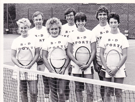 Tennis team posing with pride on the court