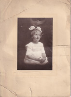 Portrait of a young girl with a bow in her hair