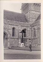 Walking past a historic church building in the sun