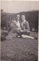 Couple relaxing on the grass in sunny weather