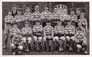 Young rugby players pose proudly at school field