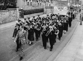 Marching band parades through city streets