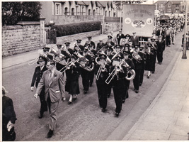 Marching band parades through city streets