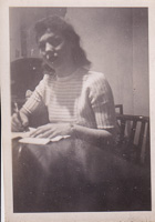 Woman writing at a rustic wooden table