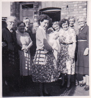 Joyful gathering of women and a baby in sunlight
