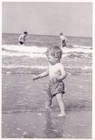 Child playing at a sunny beach shore