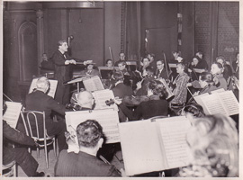 Orchestra plays under conductor's guidance