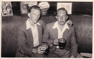 Two friends enjoying drinks in a cozy bar setting