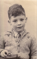 Young boy holding a toy camera, captured in time