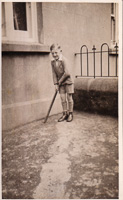 Boy happily plays cricket outside
