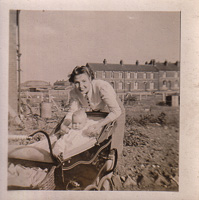 Joyful mother with baby in a sunny garden setting