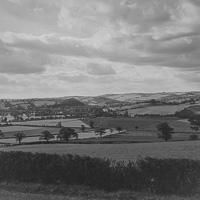 Serenity in rolling hills under a cloudy sky