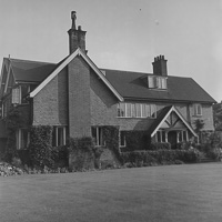 Historic manor house surrounded by lush greenery