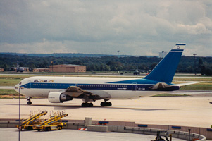 Airplane taxiing on a busy runway at an airport