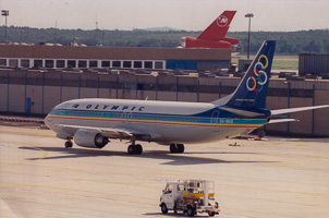 Vintage aircraft taxiing at a lively airport