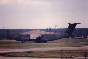 Large cargo aircraft landing at military airfield