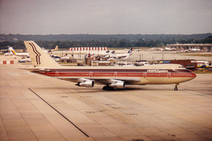 Vintage airplane taking off from a busy airport