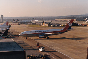 Vintage aircraft taxiing on a busy runway
