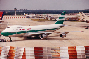 Classic airliner at a busy airport during daylight