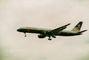 Plane gliding through clouds over city