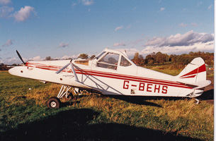 Vintage aircraft rests under a sunset sky