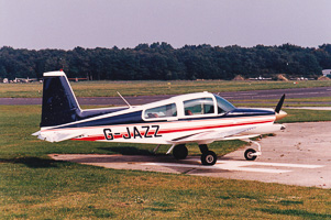 Small aircraft parked on the runway at dusk