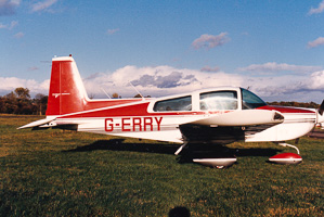 Vintage aircraft resting on a grassy runway