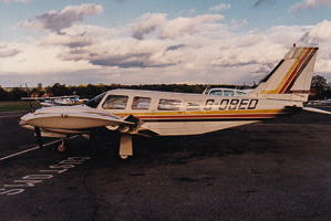 Vintage airplane parked on a runway during sunset