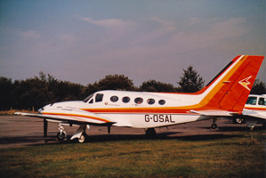 Vintage aircraft parked on the runway at dusk