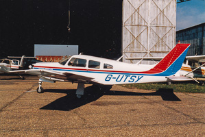 Classic aircraft parked at a small airfield
