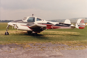 Vintage aircraft parked on a grassy airfield
