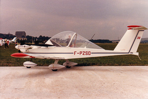 Vintage light aircraft parked on a grassy airfield