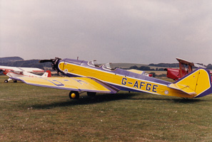 Vintage planes in a field under clouds