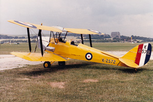 Biplane at a calm, cloudy airfield