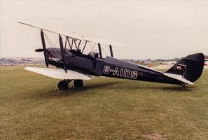Classic biplane showcased on a sunny airfield day