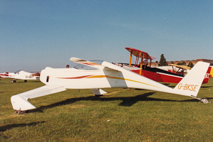 Vintage aircraft on display at a sunny airfield