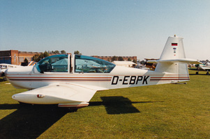 Classic aircraft parked on a sunny airfield