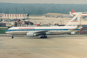 Vintage airliner taxiing at historic terminal