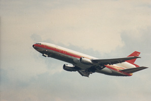 Vintage aircraft soaring above a cloudy sky