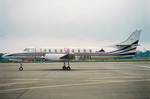 Vintage aircraft parked on runway at airport