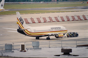 Classic aircraft being serviced at a busy airport