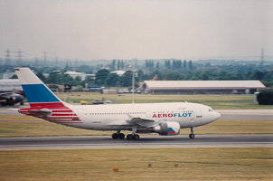 Jet in motion on a runway under cloudy skies