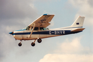 Vintage Cessna flying in cloudy skies